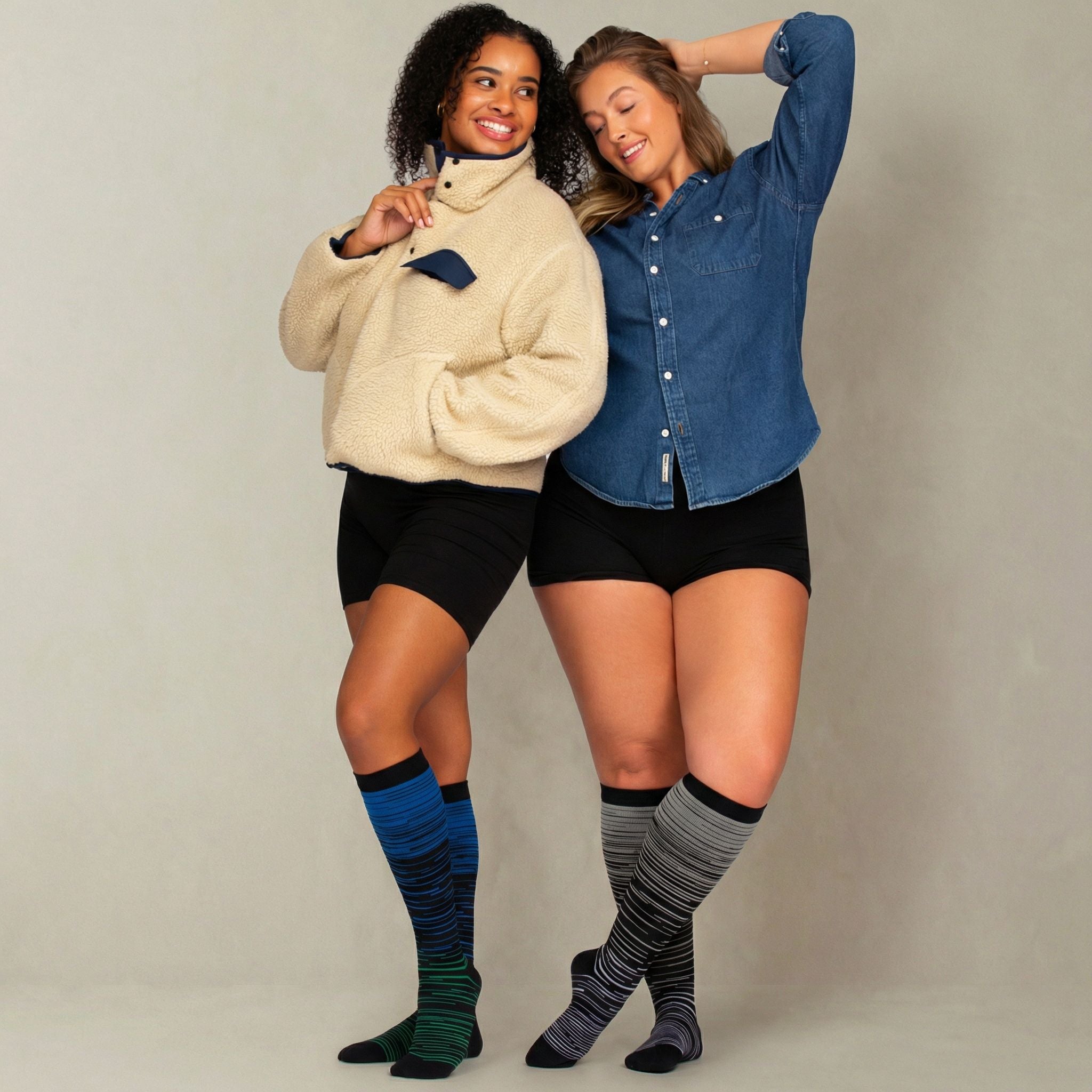 Two people wearing knee-high compression socks against a plain background